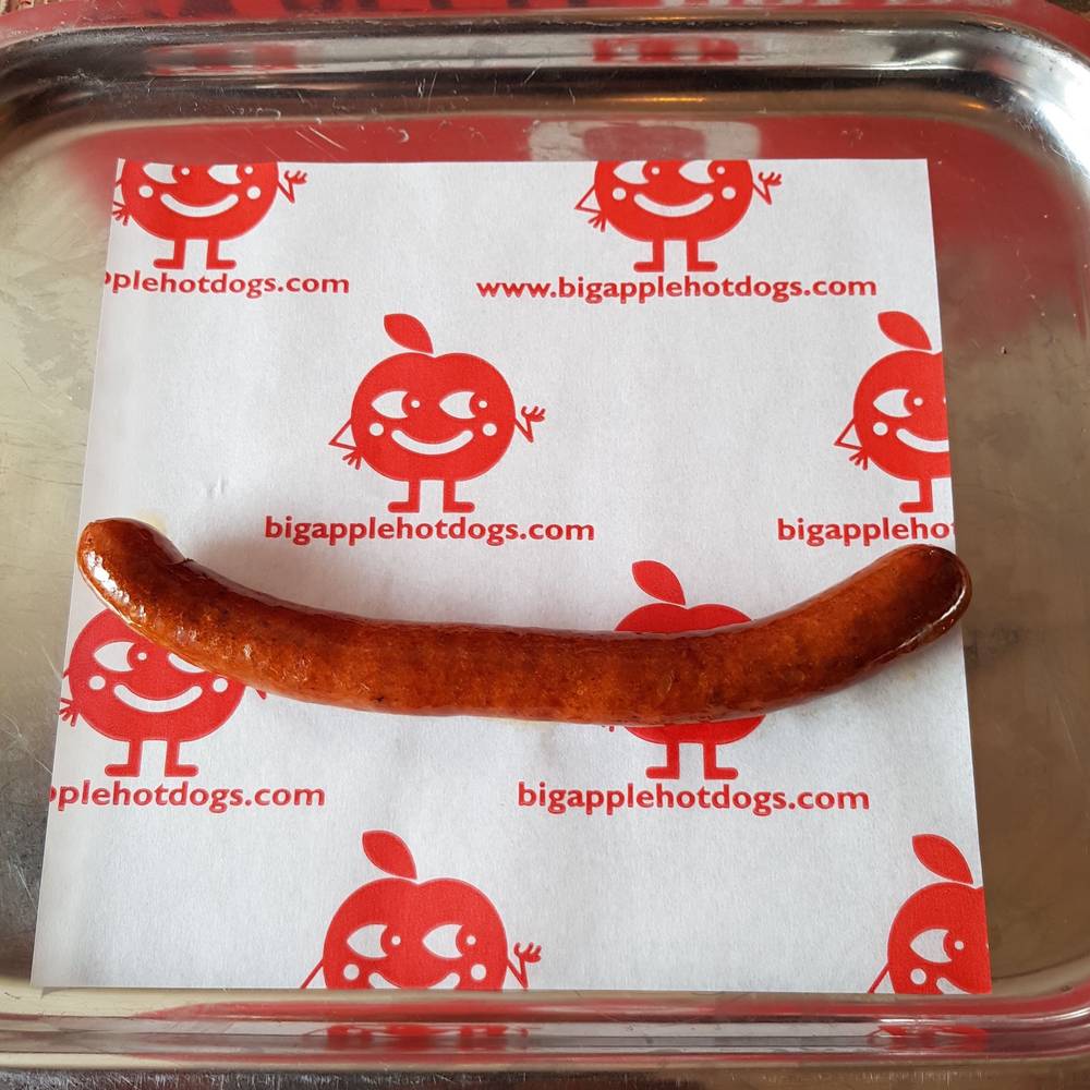 British-Bulldog-Royale-from-Big-Apple-Hot-Dogs-single-cooked-sausage-on-red-branded-wrapper-on-dish