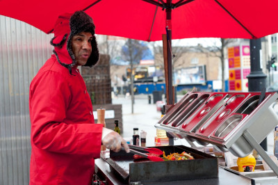 Abiye cooking hot dogs in proper British weather