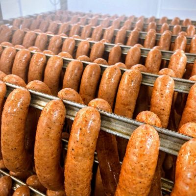 Glossy smoked frankfurters on racks